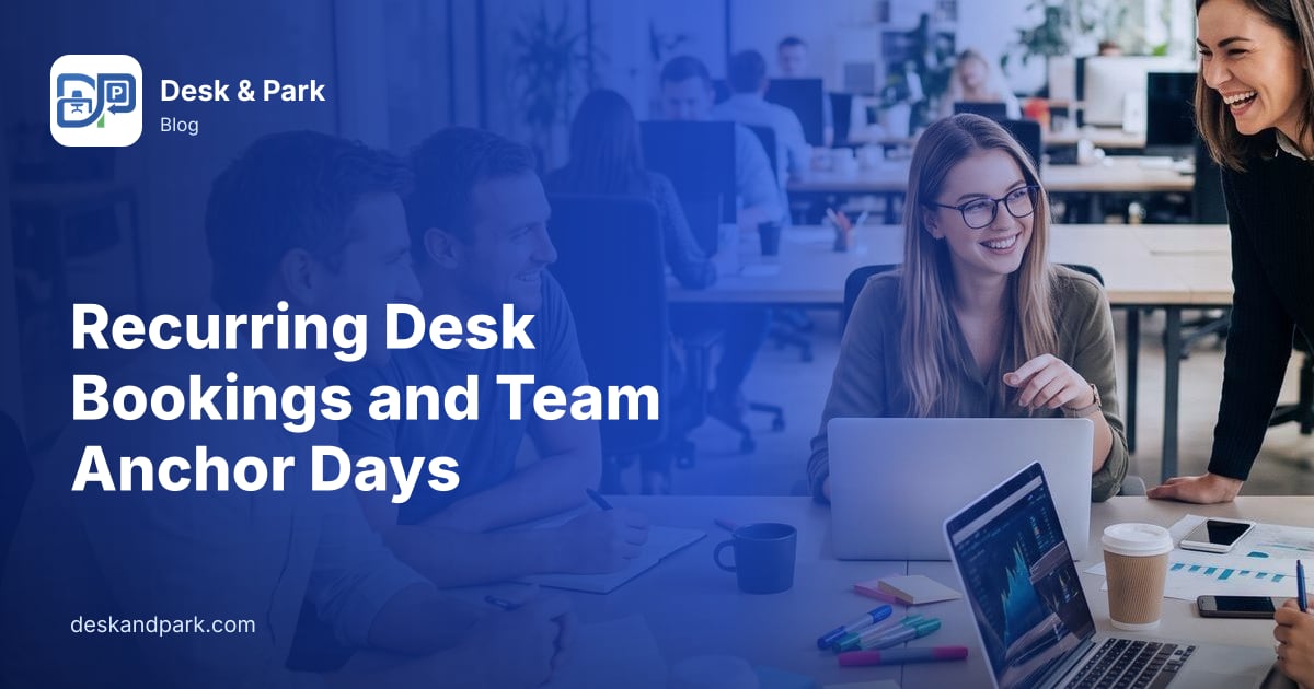A team laughing and working together at a shared table in an open-plan office